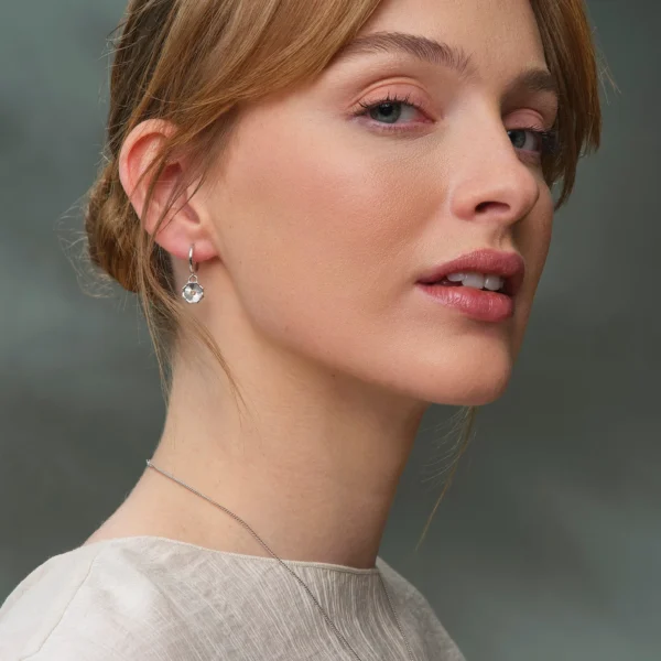 a woman with a necklace and earrings