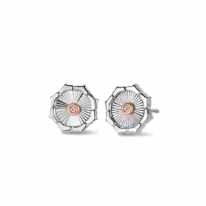 a pair of silver earrings with orange center