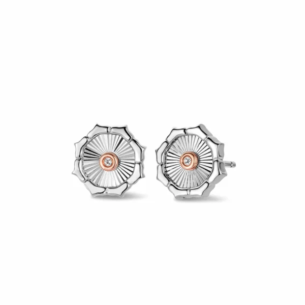 a pair of silver earrings with orange center