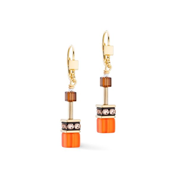 a pair of earrings with orange and brown cubes