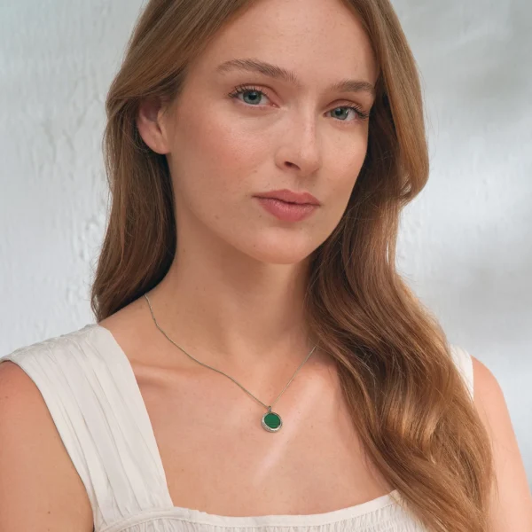 a woman with long hair wearing a necklace