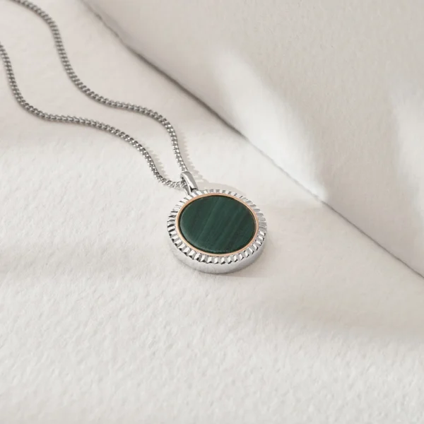 a necklace with a green stone in the middle