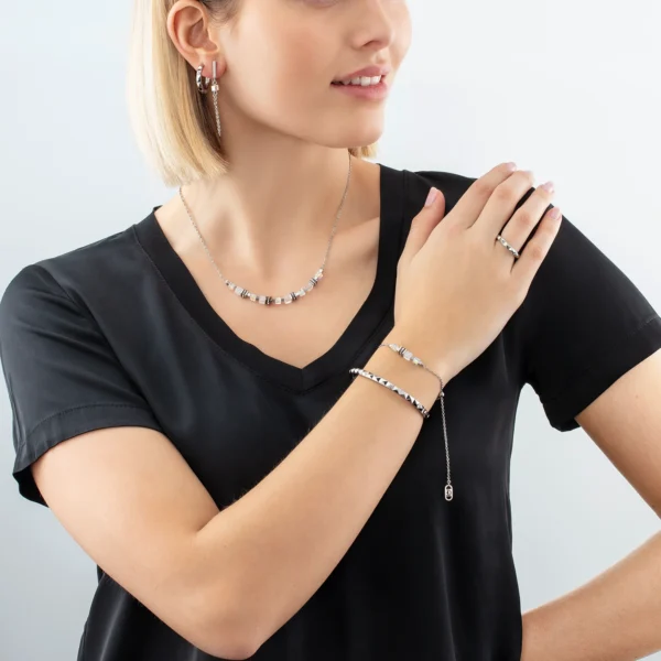 a woman wearing a black shirt and jewelry